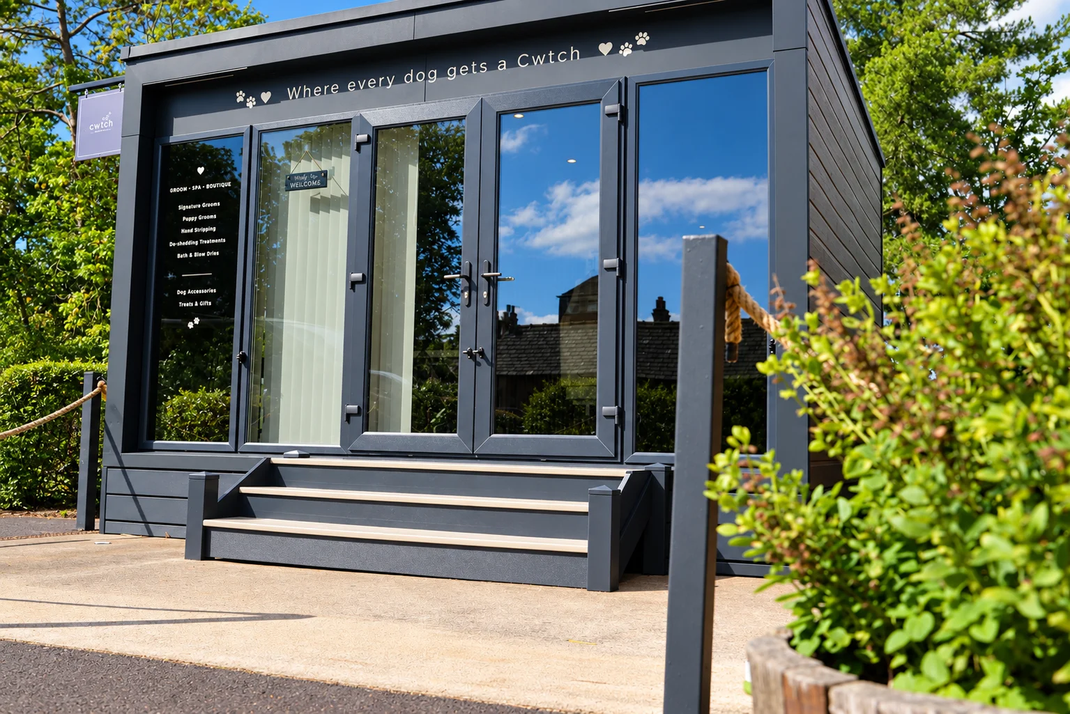 The Cwtch Groom Studio pod at The Plassey in Wrexham, featuring welcoming glass entrance and sign